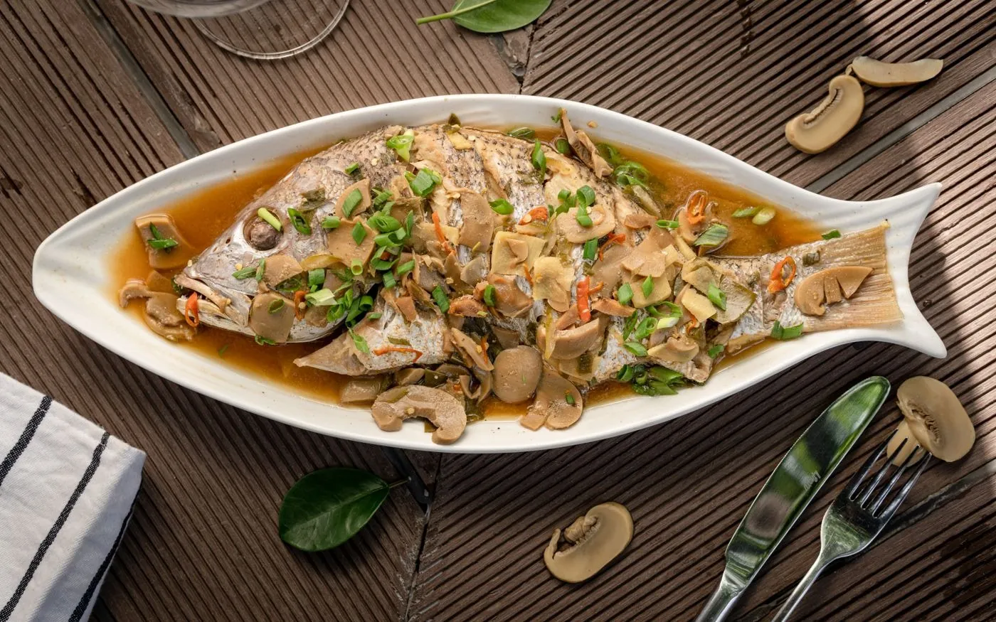Cantonese Steamed Fish with Ginger and Scallion plated Chinese dinner