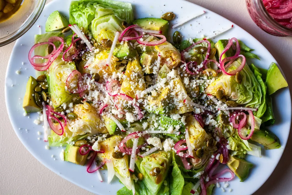 baby wedge salad with avocado and pickled onions