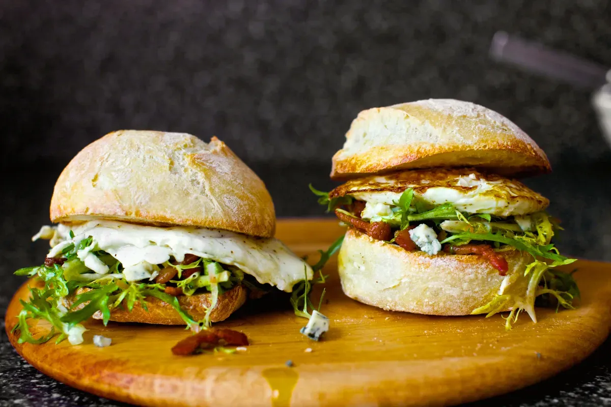 fried egg sandwich with bacon and blue cheese